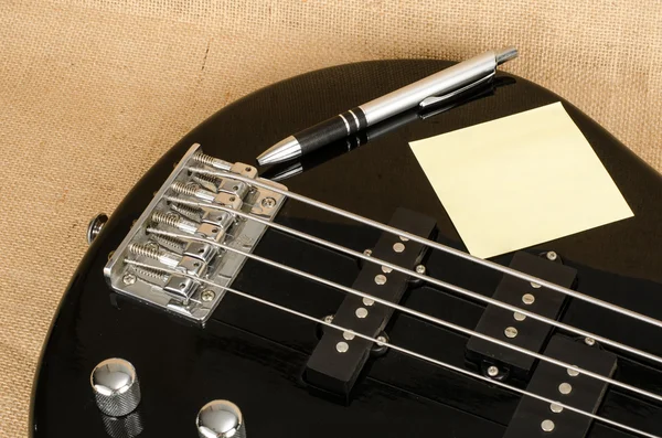 White paper on electric bass guitar — Stock Photo, Image