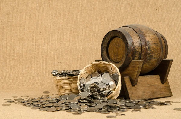 Stack of coins with wooden barrel