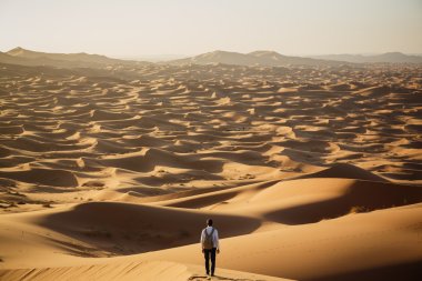 Man lost in desert dunes clipart