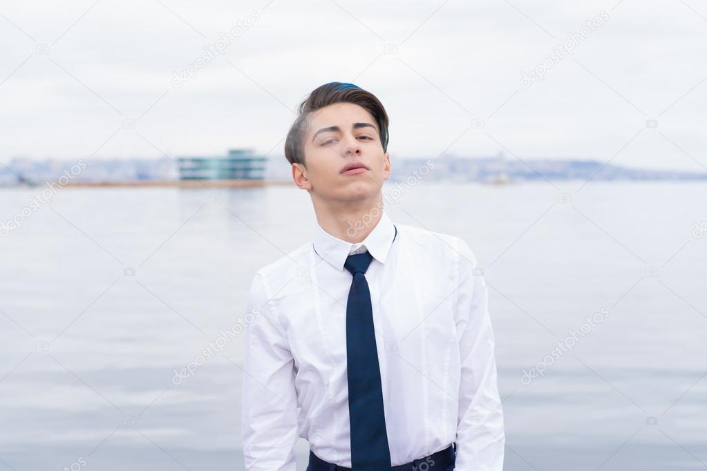  teen in a shirt and tie smokes