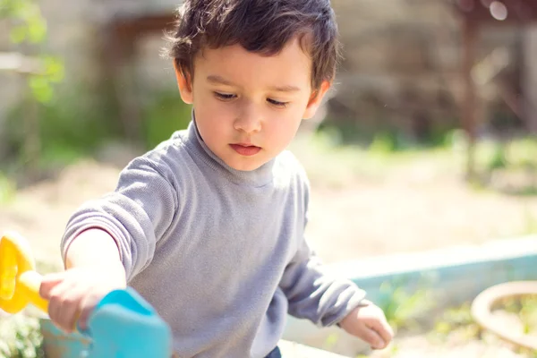 Boy playing with sand — Stock Photo, Image