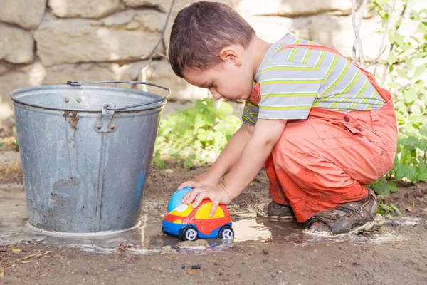 Boy plays with a machine in a pool in the summer — Stock Photo, Image