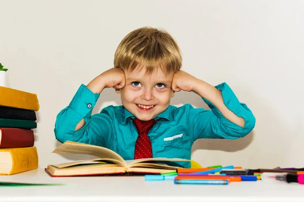 Smiling Preschool Boy Table Reading Book — Stock Photo, Image