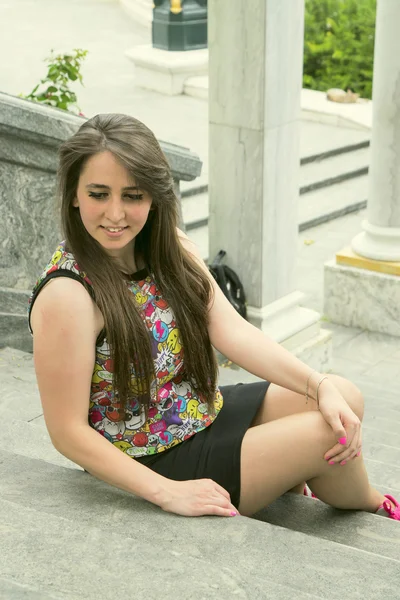 Girl sitting on stairs — Stock Photo, Image