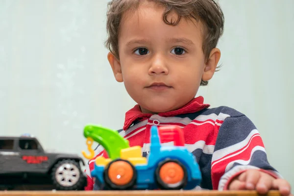 Boy playing with toy cars — Stock Photo, Image