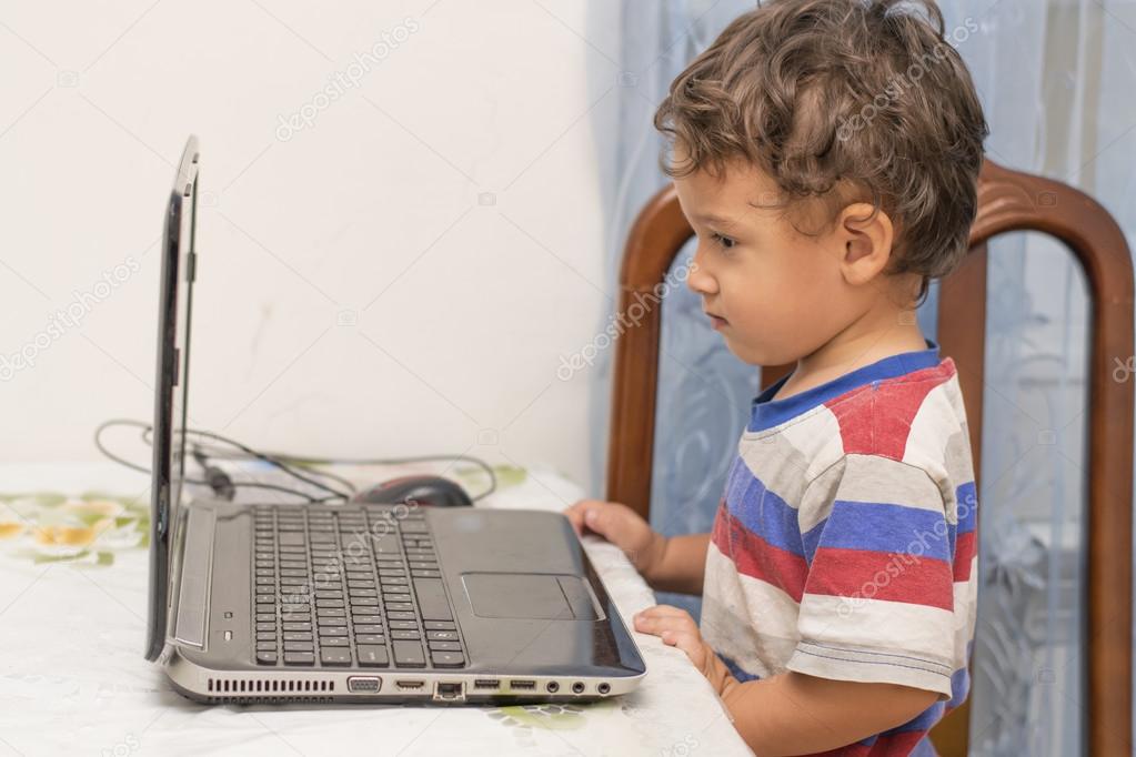 boy looks at the laptop