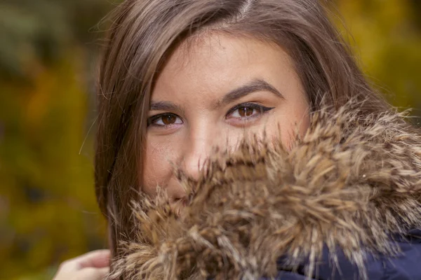 Portrait of a young woman in a jacket with fur — Stock Photo, Image