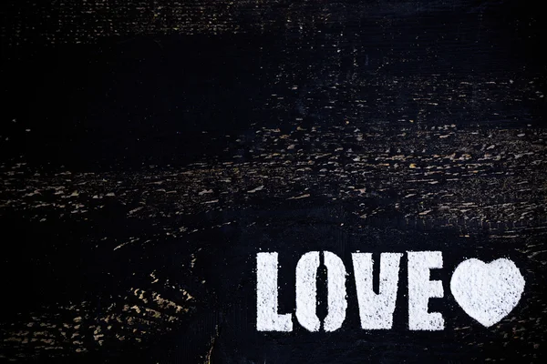 Love lettering on black wood — Stock Photo, Image