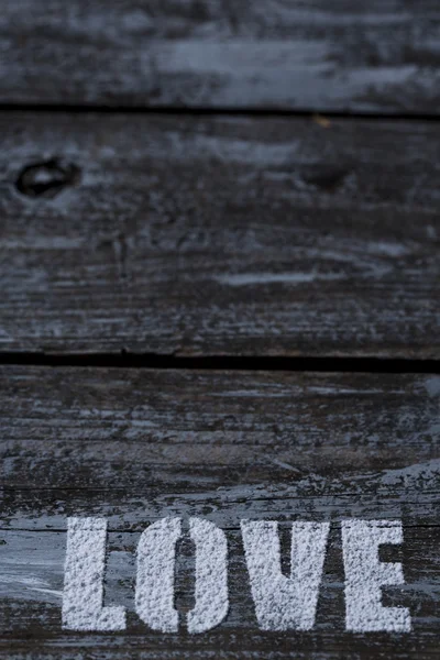 Love written on wooden background — Stock Photo, Image