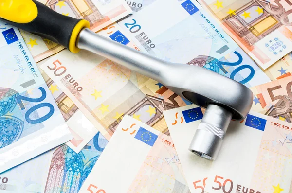 Euro banknotes and wrench — Stock Photo, Image