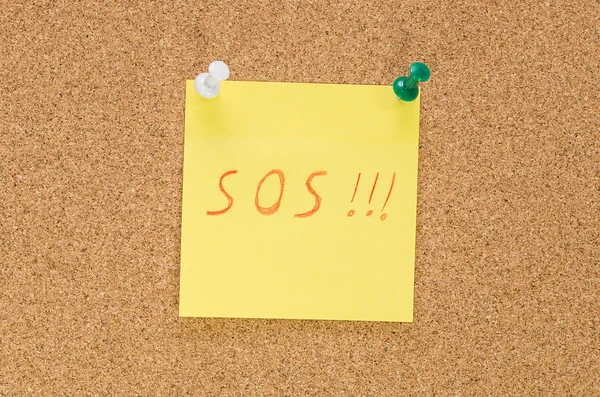 Sos note pinned on the bulletin board — Stock Photo, Image