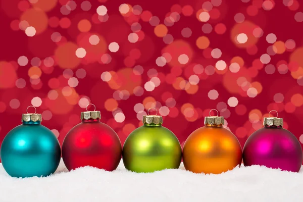 Colorful Christmas balls in a row background decoration with sno — Stockfoto