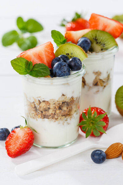 Strawberry yogurt fruit breakfast spoon healthy eating yoghurt food on a wooden board portrait format