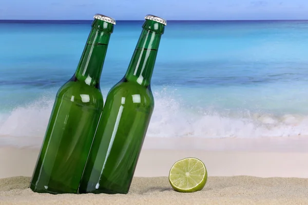 Beer in green bottles on the beach in sand — Stock Photo, Image