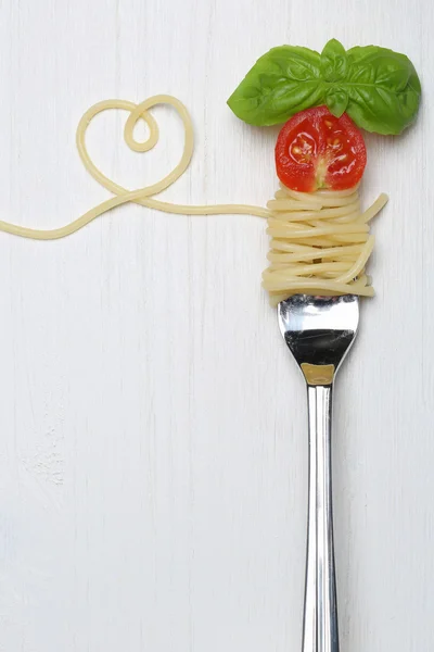 Spaghetti pasta farina con cuore e copiare lo spazio su una forchetta — Foto Stock