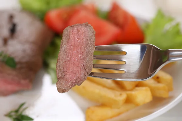 Eating beef steak meat with fork — Stock Photo, Image