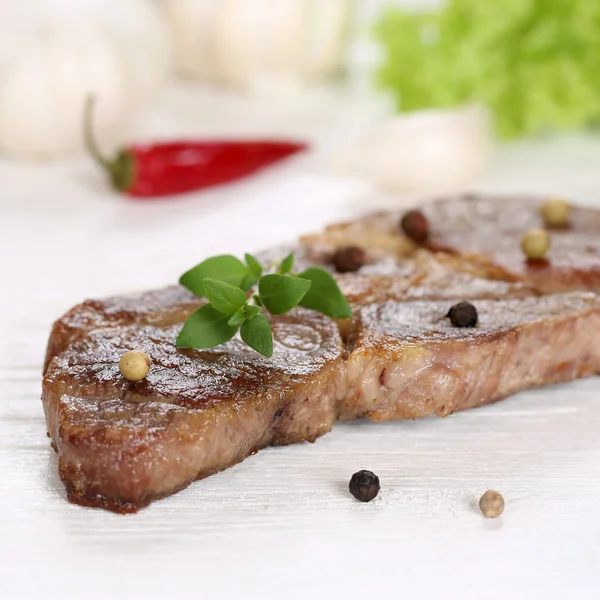 Roasted pork chop steak meat on a wooden table — Stock Photo, Image