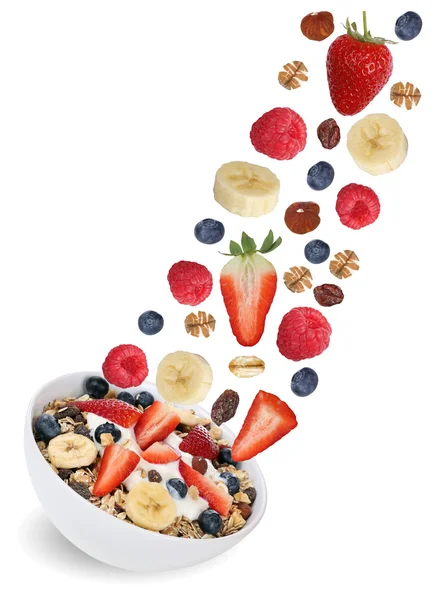 Flying fruit muesli with fruits like raspberry, banana and straw — Stock Photo, Image