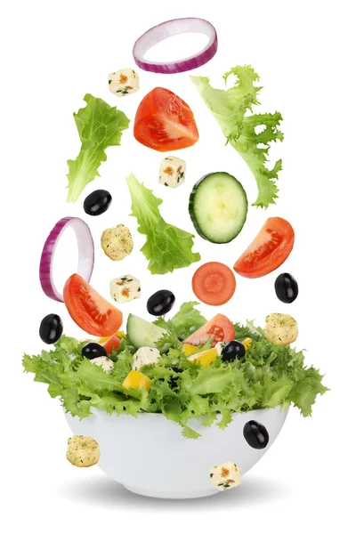 Falling salad in bowl with lettuce, tomatoes, onion and olives — Stock Photo, Image