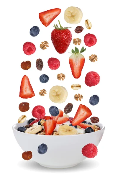 Falling ingredients of fruit muesli for breakfast in bowl with f — Stock Image Falling ingredients of fruit muesli for breakfast in bowl with f Royalty Free Stock Images