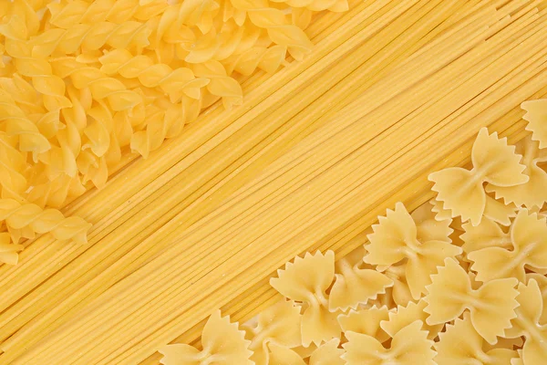 Noodles pasta spaghetti penne rigate background — Stock Photo, Image