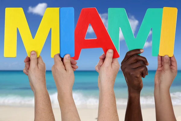 Hands holding the word Miami in summer on beach — Stock Photo, Image