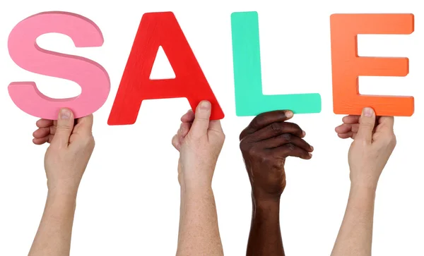 Multi ethnic group of people holding the word Sale — Stock Photo, Image