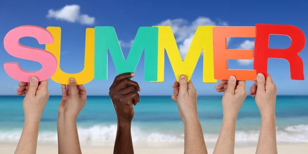 Hands holding the word summer on beach in vacation — Stock Photo, Image