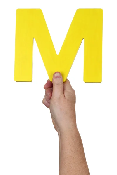 Hand holding letter M from alphabet — Stock Photo, Image