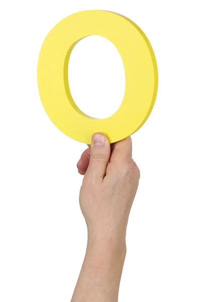 Mão segurando a letra O número 0 do alfabeto — Fotografia de Stock