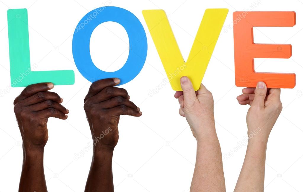 Multi ethnic group of people holding the word love