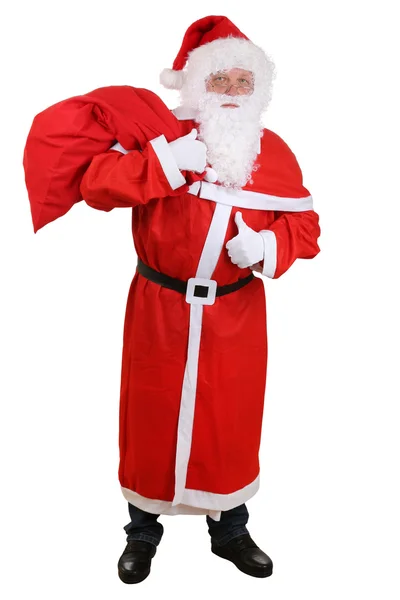 Санта-Клаус с сумкой для рождественских подарков показывает большие пальцы вверх — стоковое фото