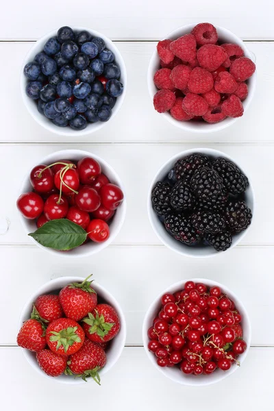 Frutas de bayas en cuencos con fresas, arándanos y cerezas — Foto de Stock