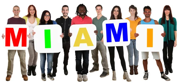 Group of young multi ethnic people holding word Miami — Stock Photo, Image