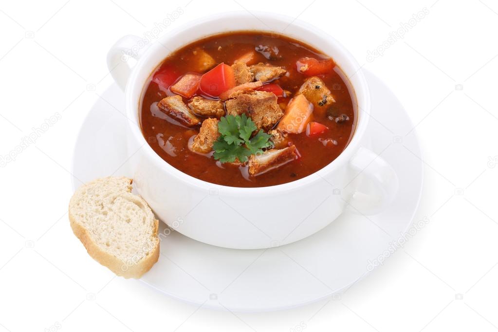 Goulash soup with meat and paprika in cup isolated