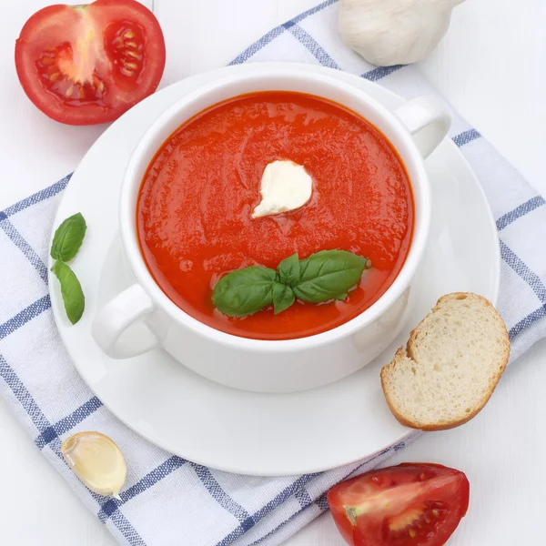 Healthy eating tomato soup with tomatoes and baguette in cup