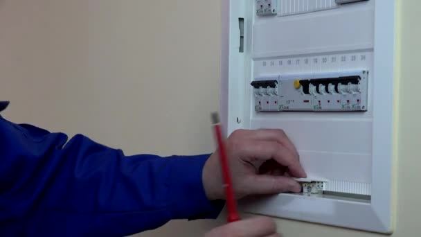 Skilled man hands repairing a circuit breaker. — Stock Video