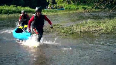 Aktif sporcular Kano vahşi su nehri itmek..