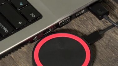 Bilgisayarın yanındaki kablosuz şarj cihazında el telefonu var. 4K