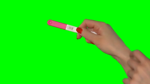 Woman pointing with finger at two red stripes on positive pregnancy test. 4K — Stock Video