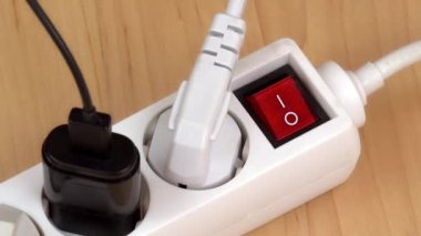 female finger switch off white extension cable cord on floor. 4K