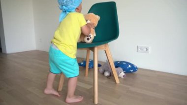 Cheerful male child playing with teddy toy bear. Positive emotion. Gimbal motion