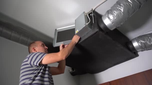 Home Owner Removing Dirty Air filter for home central air recuperation system — Stock Video