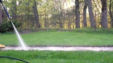 close up of female spray clean path with high water pressure. 4K