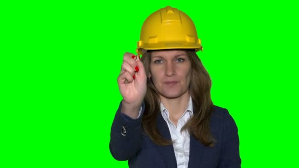 Mujer con casco mantenga las llaves de construcción de la casa. Fondo de croma verde. 4K UHD — Vídeo de stock