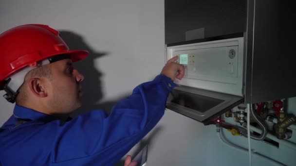Moderne technicien homme réglage des paramètres du système de chauffage avec tablette — Video