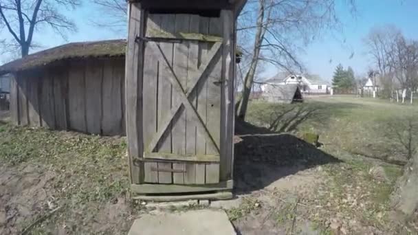 Rural wooden wc house in village. Walking into outdoor wc booth. Gimbal — Stock Video