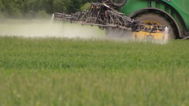 Följ traktor spray fältet växter med kemiska bekämpningsmedel — Stockvideo