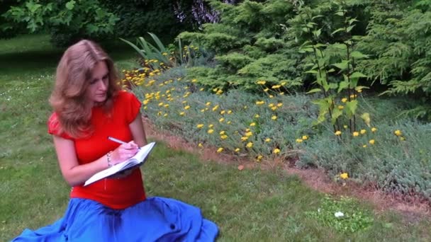 Pregnant girl write diary sit at beautiful sucullent garden — Stock Video