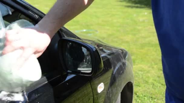 Close-up of man hand cleaning washing his car — Stock Video